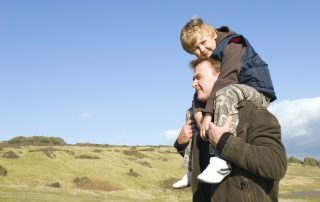 Little boy on dad's shoulders